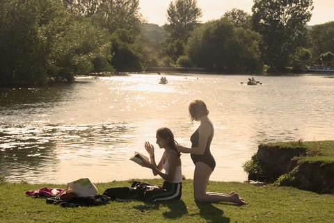 Port meadow, two people having good time by water
