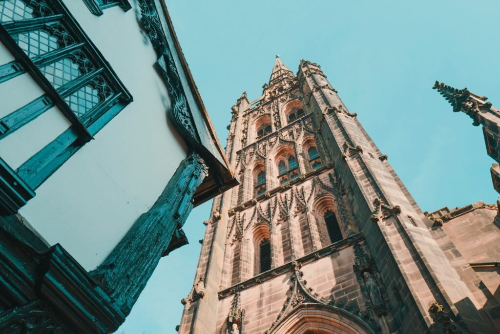 Coventry Cathedral spire and historic Tudor buildings