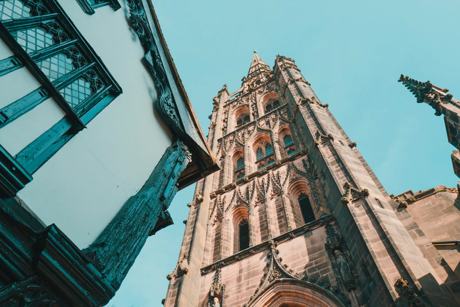 Coventry Cathedral spire and historic Tudor buildings