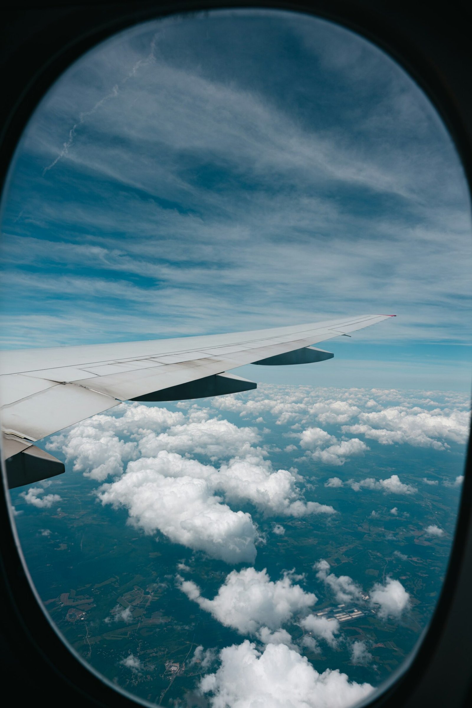 View of an airplane wing over clouds